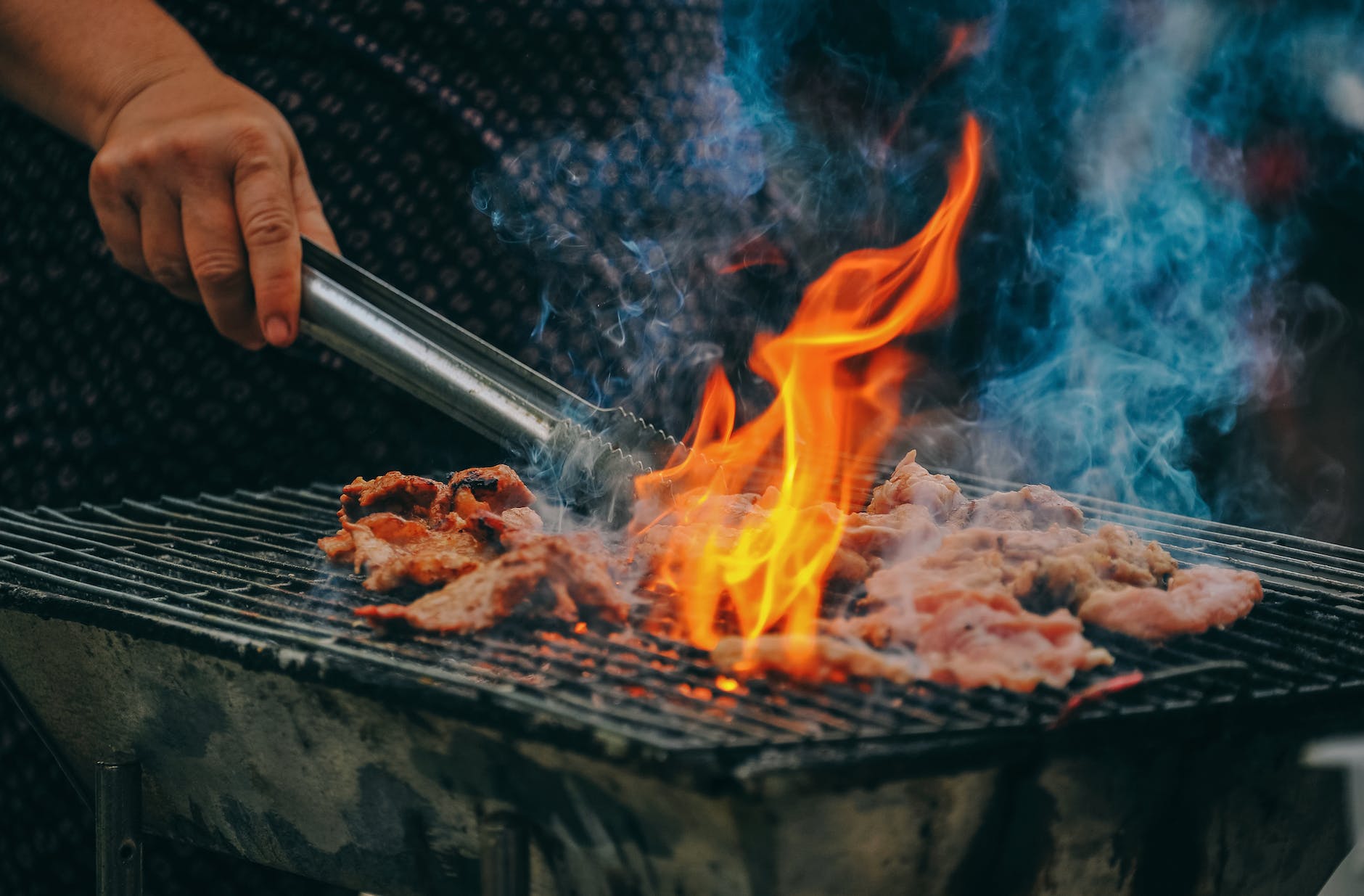 close up photo of man cooking meat